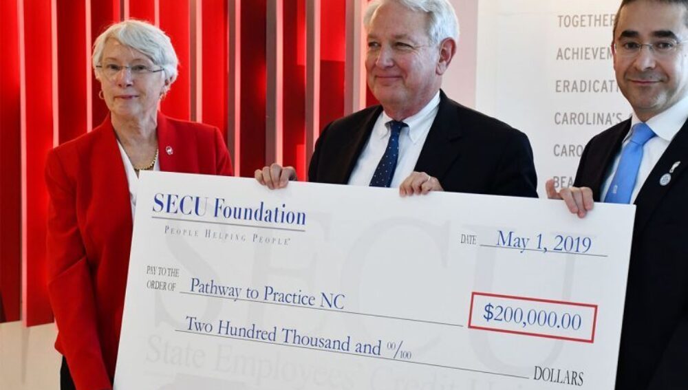 NCSU and UNC deans receiving SECU check