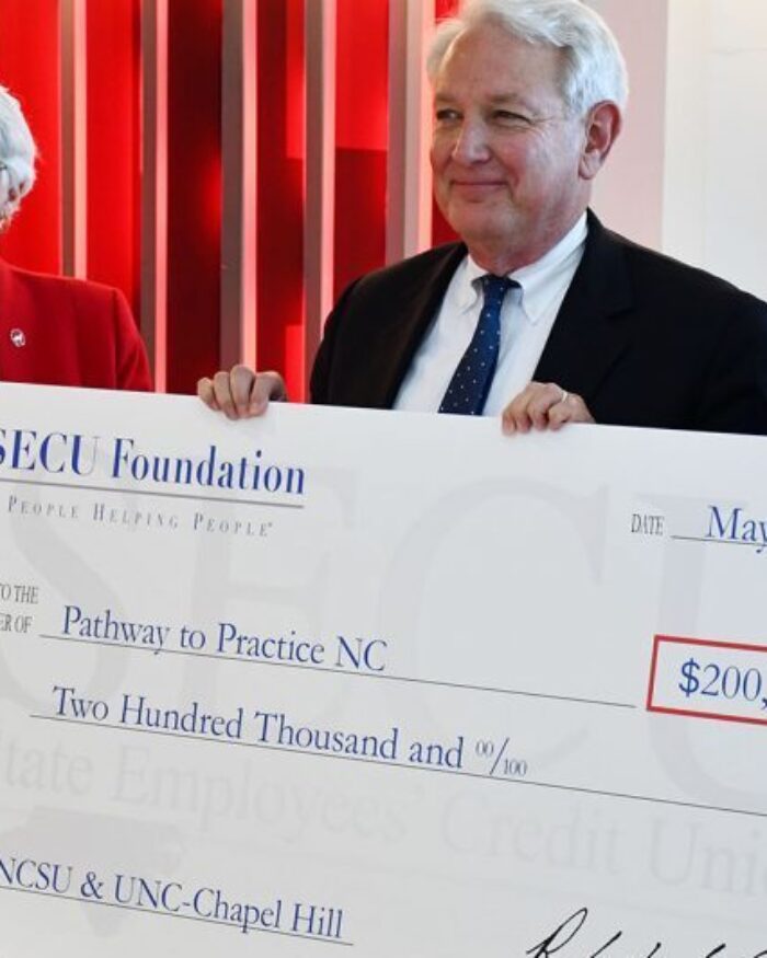 NCSU and UNC deans receiving SECU check